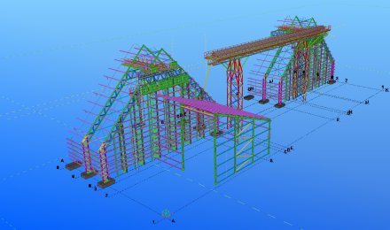 Colour-coded 3D steel model showing portal frames, trusses and a gantry structure