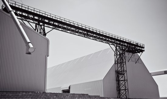 Completed steel conveyor gantry and clad industrial buildings on site